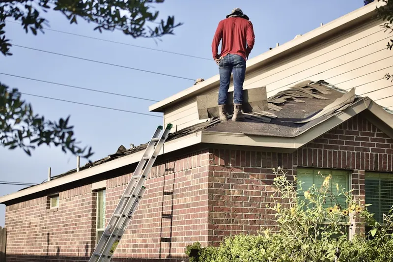 Professional roofer working on a residential roof in DFW Freeport